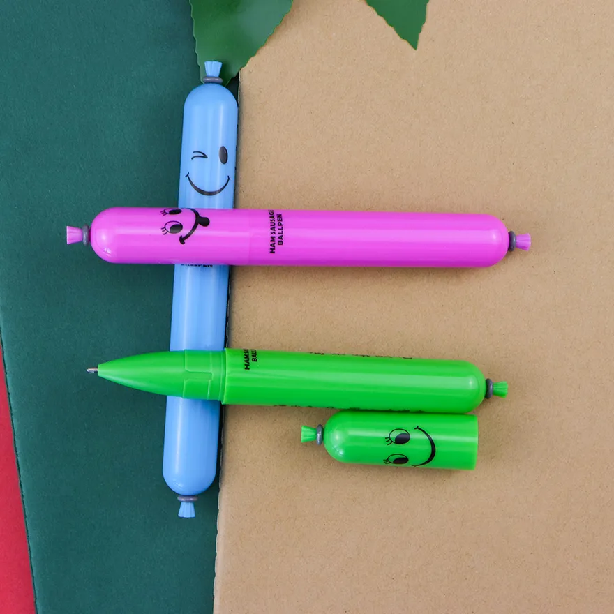 Sausage ball pens in pink, blue and green with a printed face and text